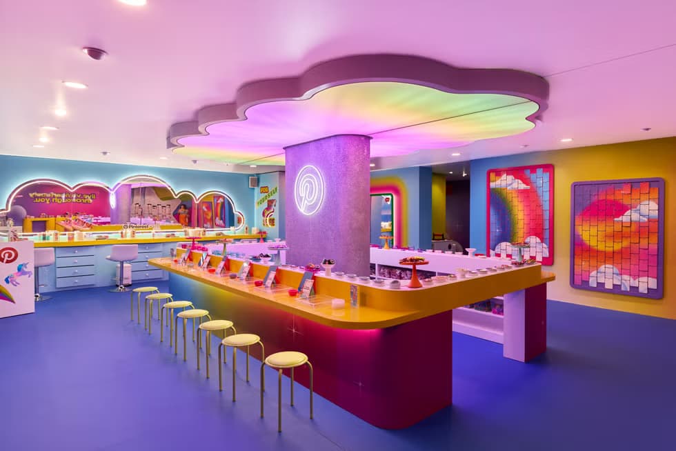 Inside Pinterest's activation: a colorful interior with treats counter and seating under a cloud-shaped canopy.