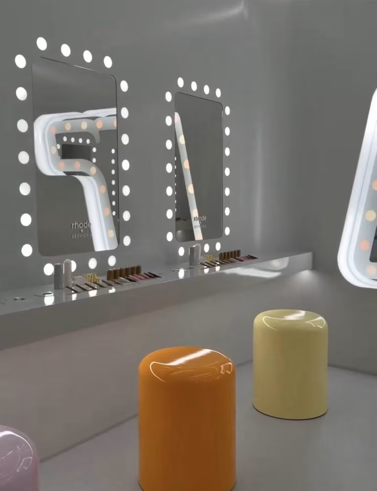 Inside Rhode World, surrounded by product displays and pink-toned lighting.
