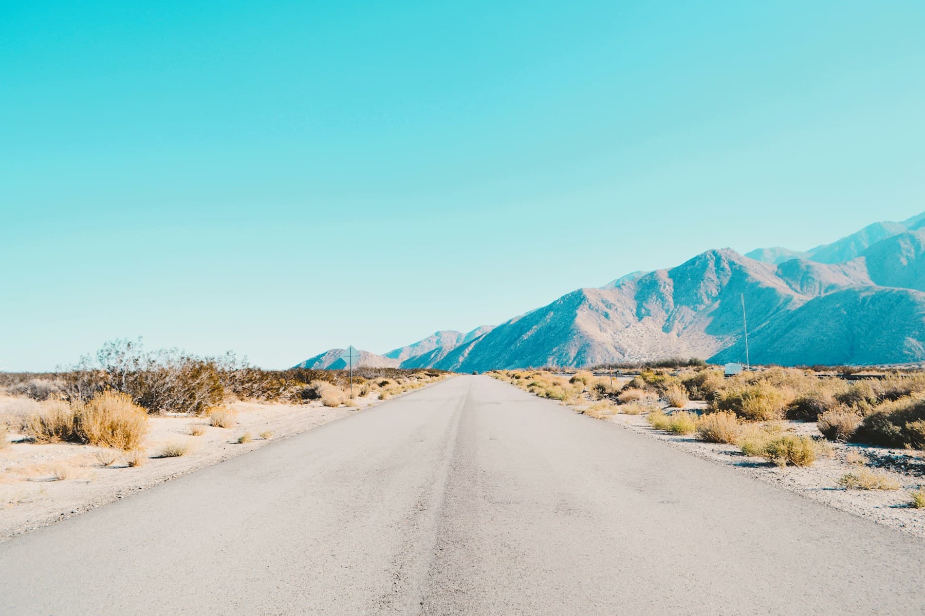 A desert road leading toward mountains near Palm Springs